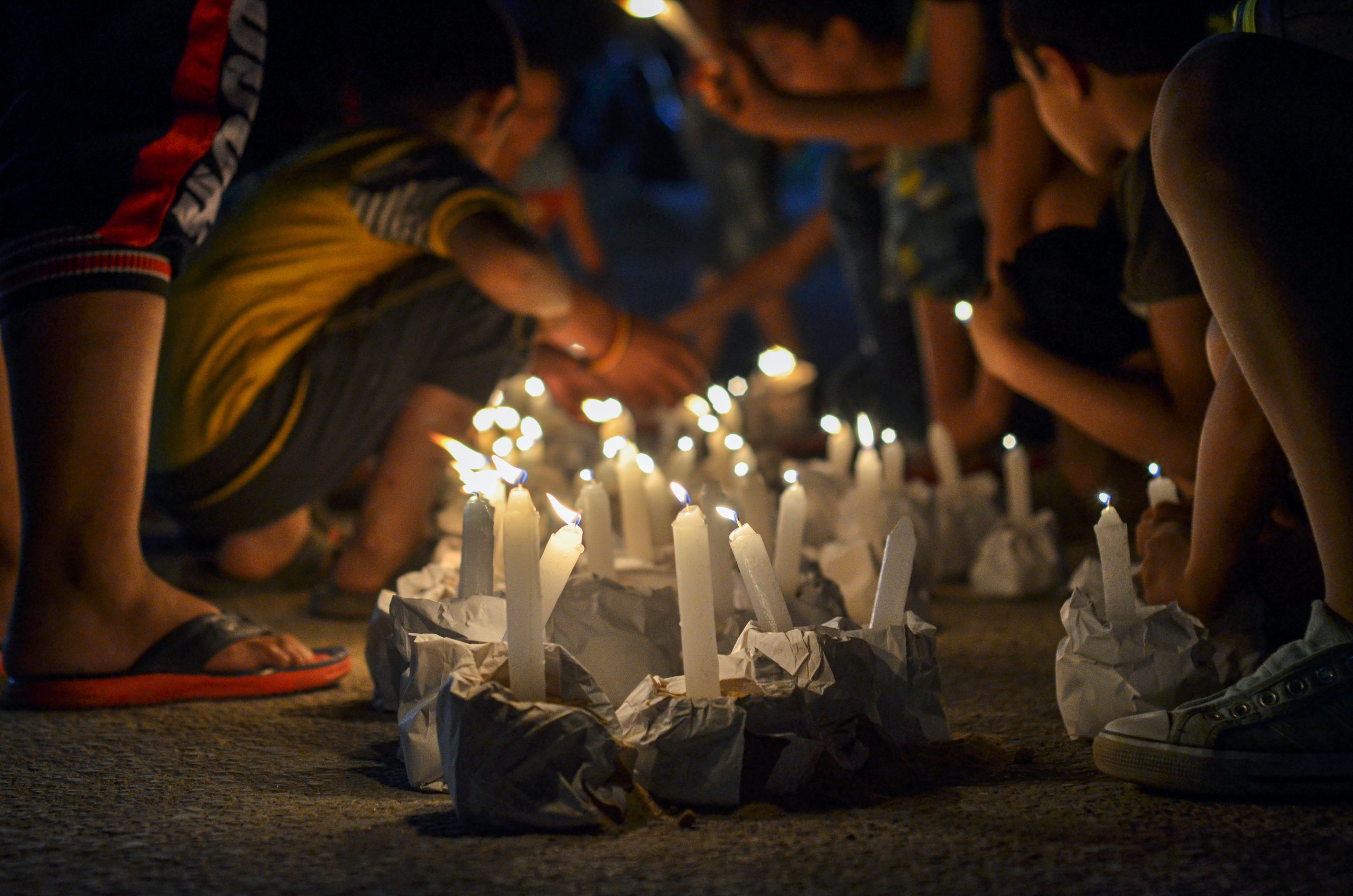 Photograph with candles surrounded by people