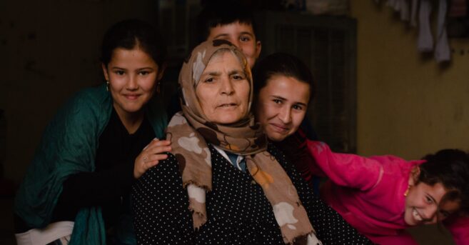 Photograph of a refugee family, a mother and her four children